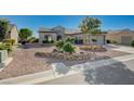 This charming single-story residence features an artfully designed xeriscaped front yard with a two car garage at 2261 Evening Lights St, Henderson, NV 89052