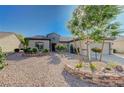 This lovely single-story home has a beautifully designed desert rock landscaped front yard at 2261 Evening Lights St, Henderson, NV 89052