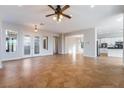 Spacious open living room featuring tile floors and doors with glass inserts leading to the outside at 2365 Black River Falls Dr, Henderson, NV 89044