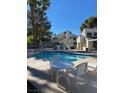 A refreshing community pool area with lounge chairs and a pristine pool at 2761 Lodestone Dr # 63, Las Vegas, NV 89117