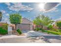 Inviting single-story home features a manicured lawn, desert landscaping, and a convenient two-car garage at 2785 Rosenhearty Dr, Henderson, NV 89044