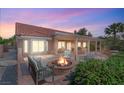 Inviting backyard with a cozy fire pit, outdoor seating, and a covered patio perfect for entertaining at 2917 Golf Links Dr, Las Vegas, NV 89134