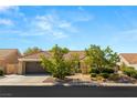 Charming single-story home with desert landscaping, a tile roof, and a two-car garage at 2917 Golf Links Dr, Las Vegas, NV 89134