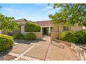 Beautiful home with a well-manicured yard and a stone walkway leading to the front door at 2917 Golf Links Dr, Las Vegas, NV 89134