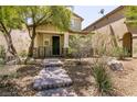 Charming home with a stone pathway leading to a covered porch and well-maintained landscaping at 3045 Camino Rico Ave, Henderson, NV 89044