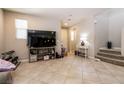 Spacious living room with tile flooring, natural light, and stairs leading up to the next level at 3045 Camino Rico Ave, Henderson, NV 89044