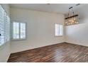 Bright living room featuring wood floors, plantation shutters, and decorative lighting at 3336 Hidden Ridge St, Las Vegas, NV 89129