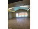Bright living room with views of the pool and vaulted ceilings, creating an airy space at 3480 E Hacienda Ave, Las Vegas, NV 89120