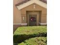 Exterior view of front door surrounded by clipped hedges, number 1 on the wall at 3609 Indigo Flower St # 1, North Las Vegas, NV 89084