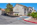 Condo building exterior features covered parking, desert landscaping, and a stucco finish, complemented by red tile roofs at 3609 Melonies Dr # 93, Las Vegas, NV 89103