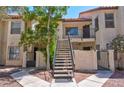 Inviting condo exterior with stairs leading to upper units, enhanced by lush landscaping and desert-friendly gravel at 3609 Melonies Dr # 93, Las Vegas, NV 89103