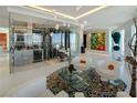 Bright living room with glass enclosed wine cellar, contemporary art, and city views at 3750 Las Vegas Blvd # 4303, Las Vegas, NV 89158