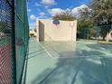 Outdoor community basketball court behind chain link fence and adjacent to a tennis court and racquetball court at 3797 Monument St, Las Vegas, NV 89121