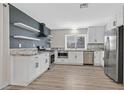 Beautiful kitchen featuring white cabinets, granite countertops, stainless steel appliances, and open shelving at 3849 Boca Chica Ave, Las Vegas, NV 89120