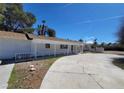 Ranch style home featuring a long, covered porch and concrete driveway at 4560 Rancho Hills Dr, Las Vegas, NV 89119