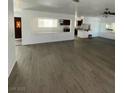 Open-concept living room with laminate flooring and connection to kitchen area at 4560 Rancho Hills Dr, Las Vegas, NV 89119