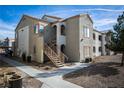 A stucco two-story condo building with stairs up to the second floor and desert landscaping at 4655 Gold Dust Ave # 206, Las Vegas, NV 89120