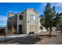 A stucco two-story condo building with stairs up to the second floor and desert landscaping at 4655 Gold Dust Ave # 206, Las Vegas, NV 89120