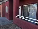 Exterior view of a unit with a white front door, a red frame, and a sliding glass door at 4730 E Craig Rd # 1148, Las Vegas, NV 89115
