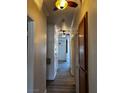 Hallway with light wood floors leading to a white front door at 4730 E Craig Rd # 1148, Las Vegas, NV 89115