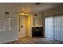 Inviting living room with wood flooring, a fireplace, and modern lighting at 4730 E Craig Rd # 1148, Las Vegas, NV 89115