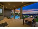 Inviting backyard with a refreshing pool, a fire pit, and an outdoor dining area under a covered patio at 4740 W Agate Ave, Las Vegas, NV 89139