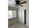 Bedroom with light colored walls, light colored floors, closet and ceiling fan at 5280 Shreve Ave, Las Vegas, NV 89156
