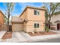 Home featuring a two-car garage, complemented by desert landscaping for low maintenance at 5280 Shreve Ave, Las Vegas, NV 89156