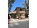 A view of the exterior elevation of the home with a two-car garage and well-kept landscape at 5280 Shreve Ave, Las Vegas, NV 89156