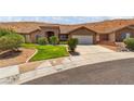 Charming single-story home features desert landscaping, a stone facade entry, and attached two car garage at 574 Desert Tortoise Way, Mesquite, NV 89027