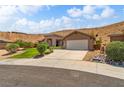 Charming single-story home features desert landscaping, a stone facade entry, and attached two car garage at 574 Desert Tortoise Way, Mesquite, NV 89027