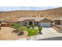 Charming single-story home features desert landscaping, a stone facade entry, and attached two car garage at 574 Desert Tortoise Way, Mesquite, NV 89027