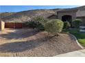 Low-maintenance desert landscaping with decorative rock and mature plantings at 574 Desert Tortoise Way, Mesquite, NV 89027