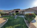 Charming home featuring a well-manicured lawn and desert-friendly landscaping at 574 Desert Tortoise Way, Mesquite, NV 89027