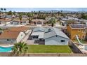This aerial shows a fenced in backyard, manicured lawn, patio, and desert landscaping at 6553 Baywood Ave, Las Vegas, NV 89103