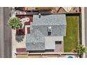 Aerial view of home featuring mature landscaping, grey roof, manicured lawn, and fenced yard at 6553 Baywood Ave, Las Vegas, NV 89103