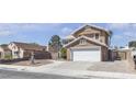 Charming two-story home with a well-manicured yard, a two-car garage and elegant front yard landscaping at 7197 Sixshooter Dr, Las Vegas, NV 89119