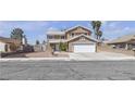 Charming two-story home with a well-manicured yard, a two-car garage and elegant front yard landscaping at 7197 Sixshooter Dr, Las Vegas, NV 89119