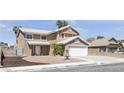 Attractive two-story home with a two-car garage and elegantly landscaped front yard at 7197 Sixshooter Dr, Las Vegas, NV 89119