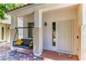 Inviting front porch with a swing and a colorful welcome mat by the front door at 7900 Dutch Canyon Ct, Las Vegas, NV 89131