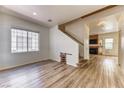 Spacious living room featuring hardwood floors, stairs, a fireplace, and a rustic decor at 7900 Dutch Canyon Ct, Las Vegas, NV 89131