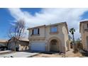 Beautiful two-story home with neutral stucco exterior, an attached garage, and an arched front entry at 8149 Palace Monaco Ave, Las Vegas, NV 89117