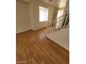 Bright living area featuring hardwood floors, staircase and a view to the entry way at 8149 Palace Monaco Ave, Las Vegas, NV 89117