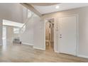 Bright entryway with wood-look floors and a staircase leading to the second level at 8307 Fort Hallock Ave, Las Vegas, NV 89131