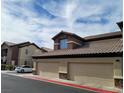 Condominium featuring private garages and exterior architectural details at 8324 W Charleston Blvd # 2033, Las Vegas, NV 89117
