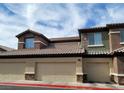 Exterior view of condos with private garages in a well-maintained community at 8324 W Charleston Blvd # 2033, Las Vegas, NV 89117
