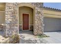 Close-up of the front door showcasing stone detail and craftsman design at 9120 Parkstone Ave, Las Vegas, NV 89178