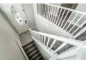 Bright foyer featuring a staircase with white railings and gray flooring at 9750 Maple Sugar Leaf Pl, Las Vegas, NV 89148