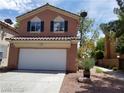 Two-story home featuring an attached garage, standard driveway, and desert-style xeriscape at 9937 La Paca Ave, Las Vegas, NV 89117