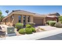 Inviting single-story home showcasing a tile roof, landscape, and paved driveway at , North Las Vegas, NV 89084
